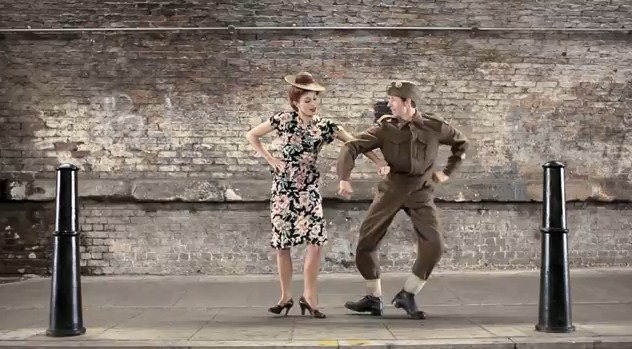 Man and woman dancing in clothing of the WWII era