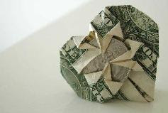 Money origami - Dollar bill folded into a heart around a coin