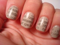 Woman's hand with newsprint art fingernails