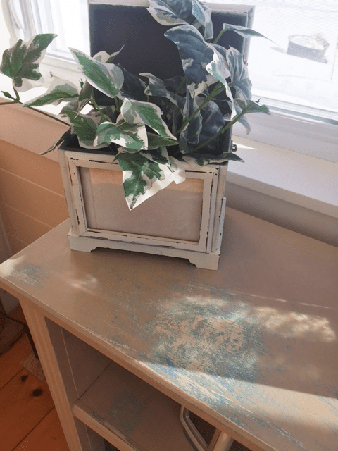 Top of MDF bookcase with distressed paint finish lighter